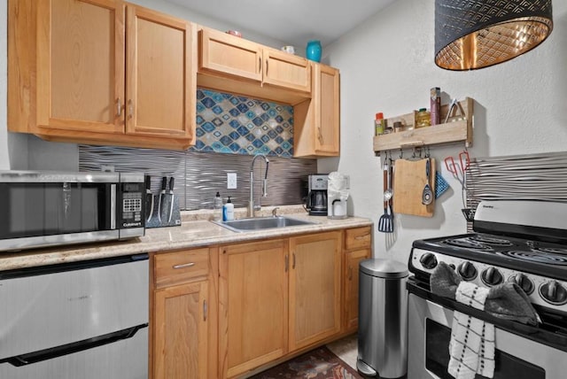 kitchen with appliances with stainless steel finishes, sink, decorative backsplash, and light brown cabinets