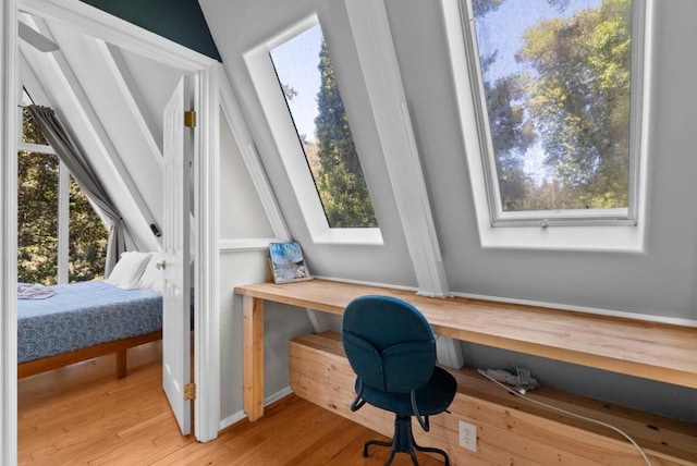 office with light hardwood / wood-style flooring and built in desk