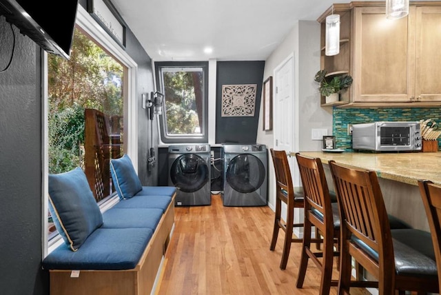 washroom featuring washer and dryer and light hardwood / wood-style flooring