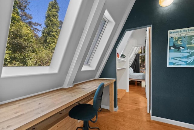 home office with built in desk and wood-type flooring