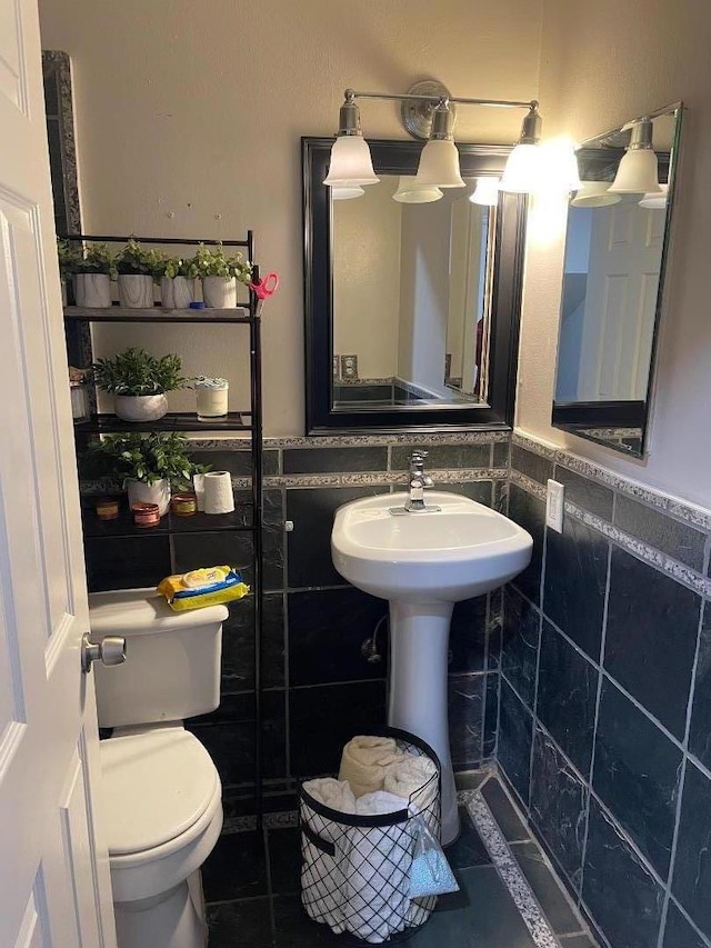 bathroom featuring sink, tile walls, tile patterned floors, and toilet