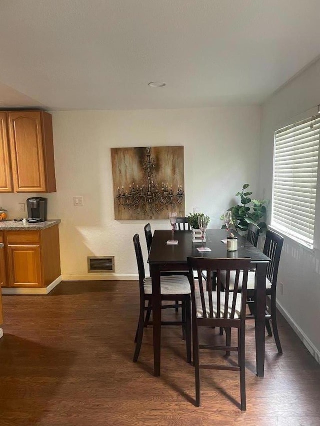 dining area with dark hardwood / wood-style flooring