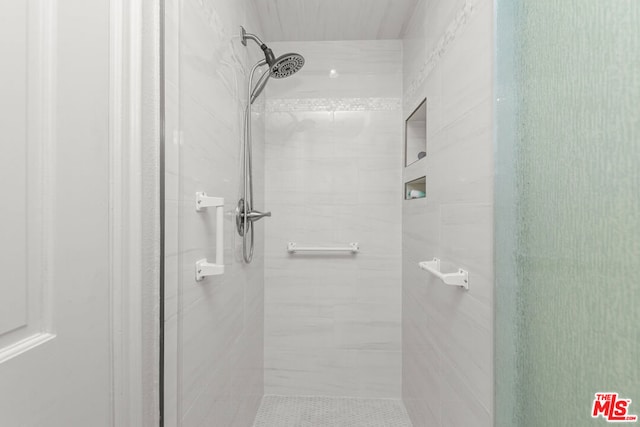 bathroom with a shower with shower door