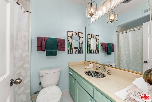 bathroom featuring vanity, ornamental molding, and toilet