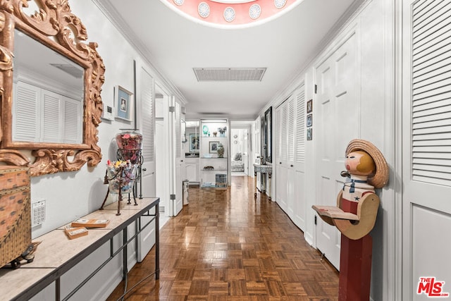 corridor featuring dark parquet flooring and crown molding