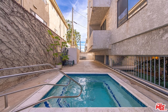 view of swimming pool featuring a patio