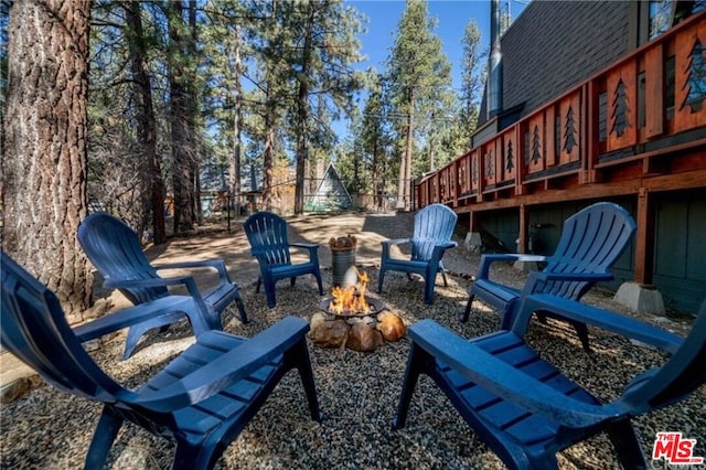 view of patio / terrace featuring a wooden deck and a fire pit