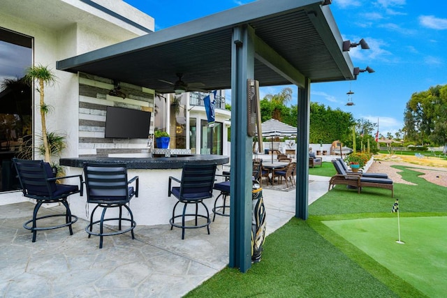 view of patio featuring ceiling fan and an outdoor bar