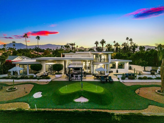 surrounding community with a mountain view and a patio area