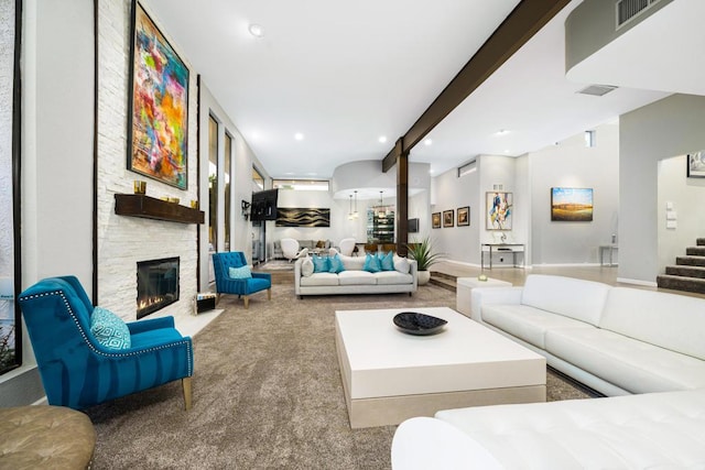 carpeted living room featuring a fireplace and beam ceiling