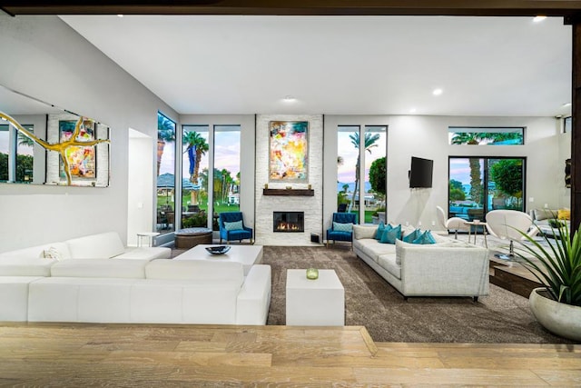 living room with wood-type flooring and a fireplace