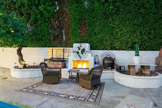 view of patio / terrace with an outdoor fireplace