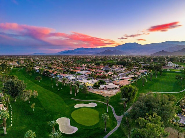 aerial view at dusk featuring a mountain view