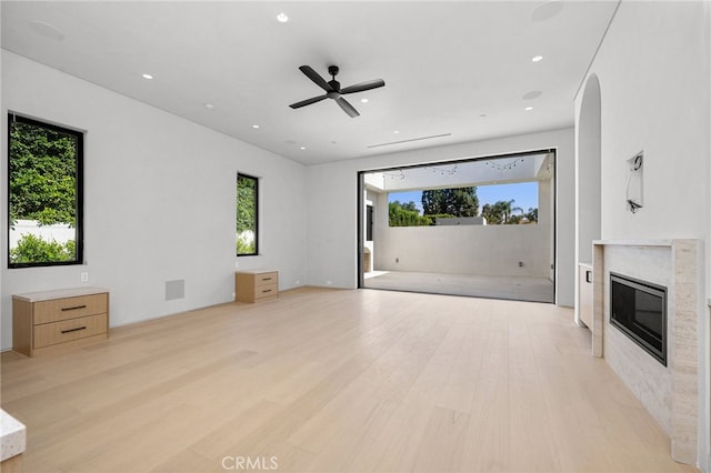 unfurnished living room featuring ceiling fan and light hardwood / wood-style floors