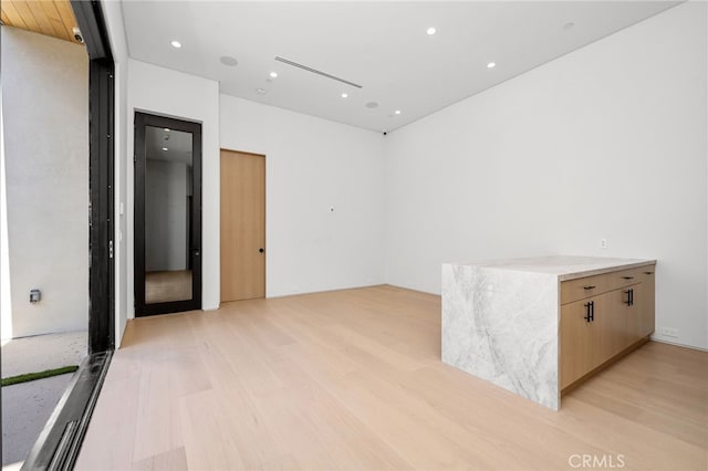 empty room with light hardwood / wood-style floors