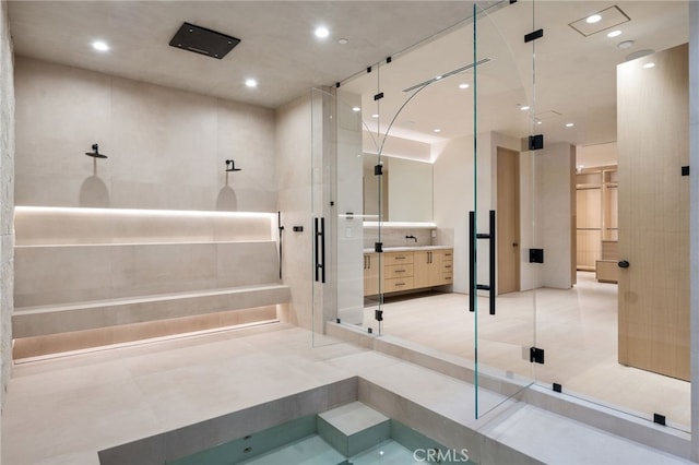 bathroom with vanity, an enclosed shower, and tile patterned flooring