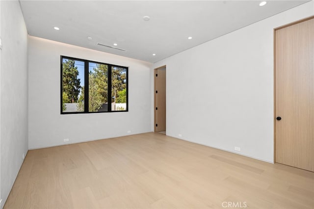 spare room with light wood-type flooring