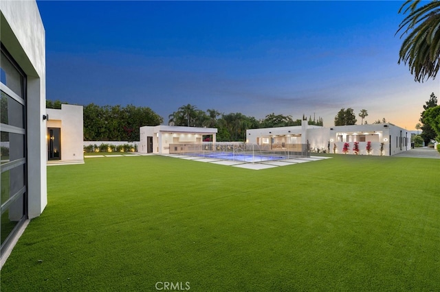 yard at dusk featuring a patio area