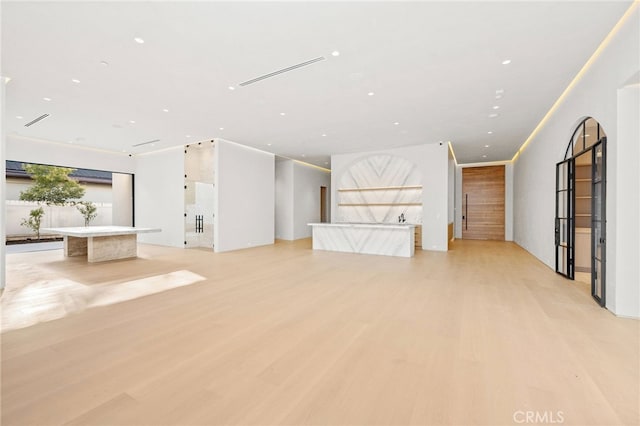 unfurnished living room with light wood-type flooring