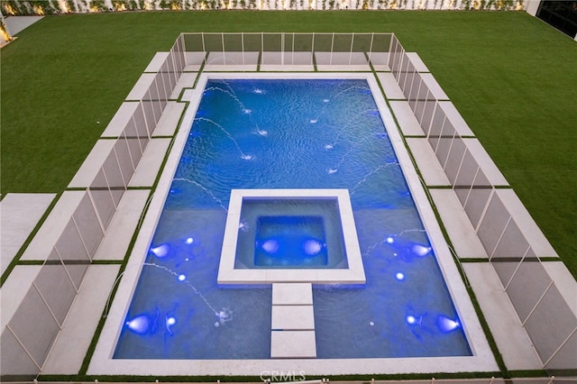 view of swimming pool with an in ground hot tub, pool water feature, and a lawn