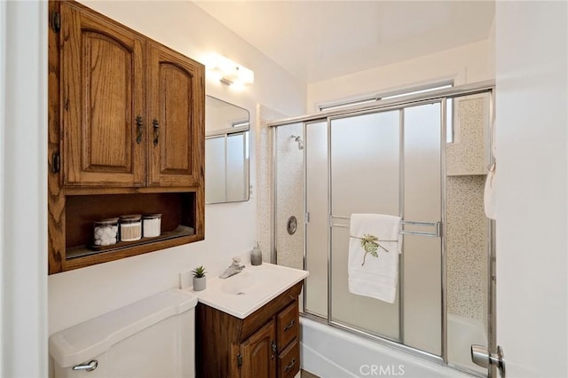 full bathroom with vanity, bath / shower combo with glass door, and toilet