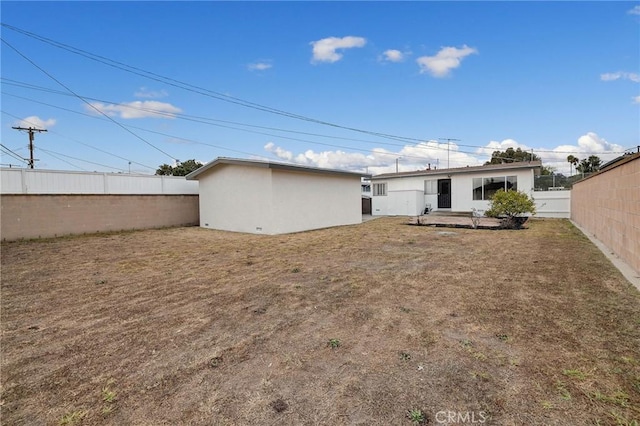 back of house with a lawn