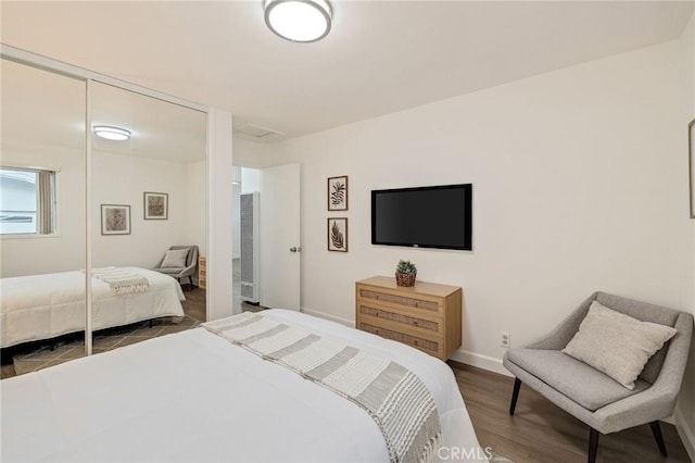 bedroom with hardwood / wood-style floors and a closet