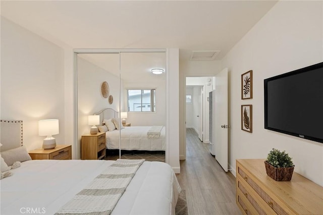 bedroom with hardwood / wood-style flooring and a closet