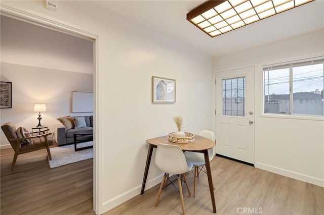 dining space with light hardwood / wood-style floors