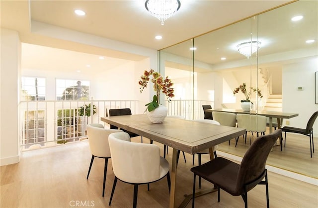 dining space featuring a chandelier and light hardwood / wood-style flooring