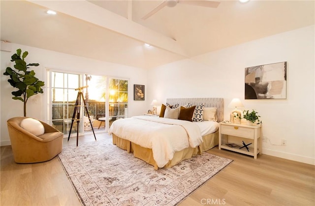 bedroom featuring ceiling fan, light hardwood / wood-style floors, and lofted ceiling with beams