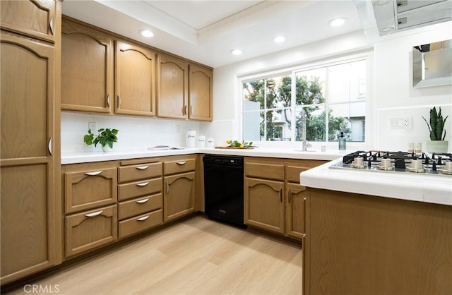 kitchen featuring crown molding, stainless steel gas stovetop, a raised ceiling, and light hardwood / wood-style flooring