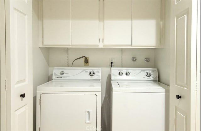 laundry room with cabinets and washer and dryer