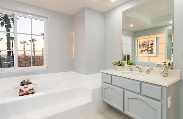 bathroom featuring vanity and tiled bath