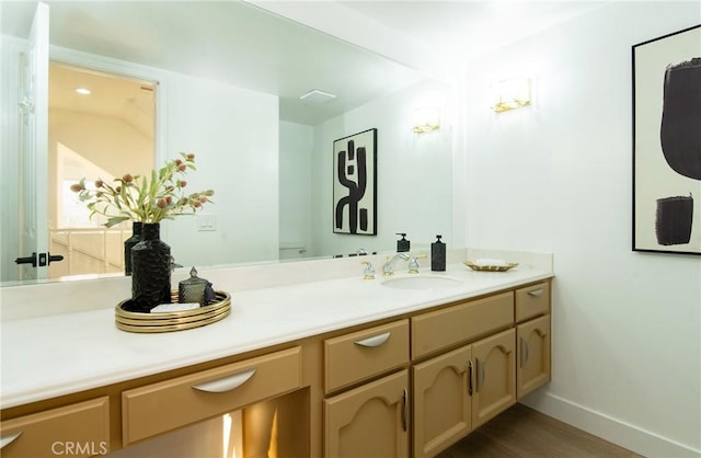 bathroom with vanity, wood-type flooring, and toilet