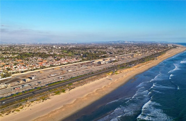 birds eye view of property featuring a beach view and a water view