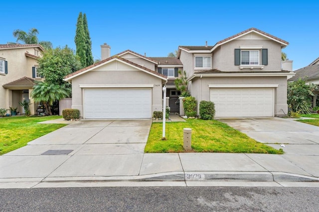 view of front property with a garage and a front lawn