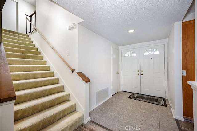 entrance foyer with a textured ceiling