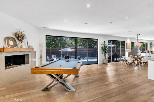 recreation room with light wood-type flooring and billiards