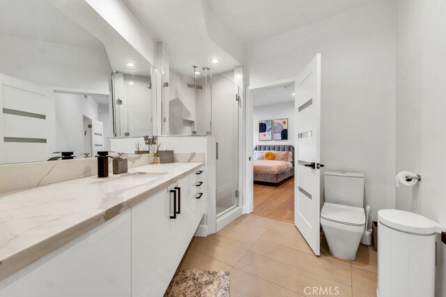 bathroom with vanity, tile patterned floors, and toilet