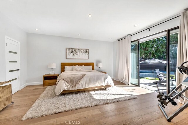 bedroom with access to outside and light wood-type flooring