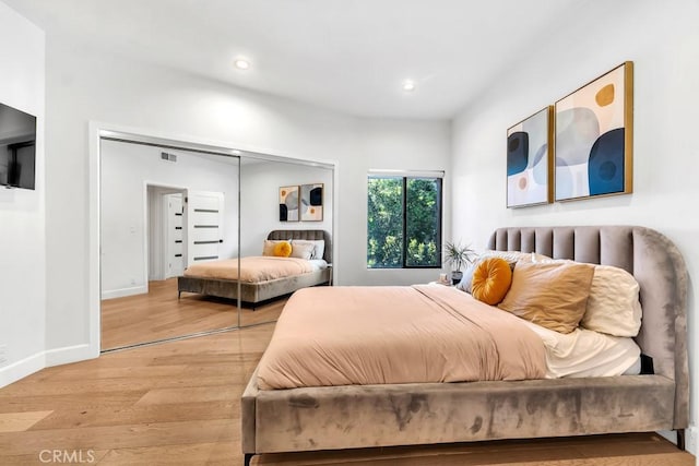 bedroom featuring light hardwood / wood-style flooring and a closet