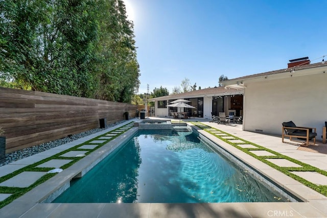 view of pool with a patio area and an in ground hot tub
