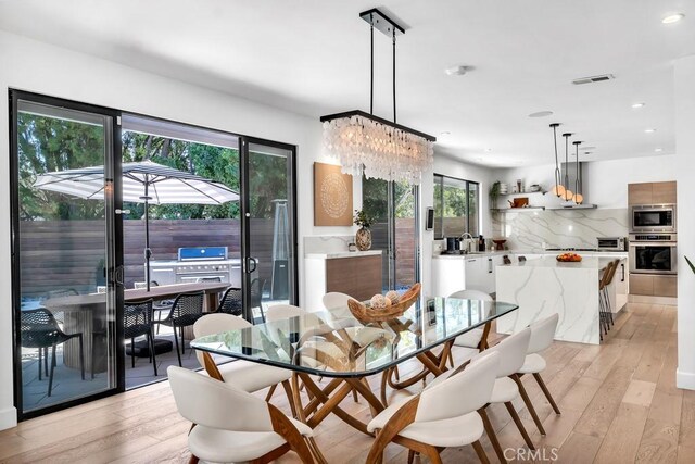 dining space with light hardwood / wood-style flooring