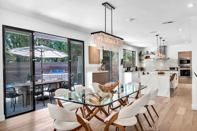 dining space with light wood-type flooring