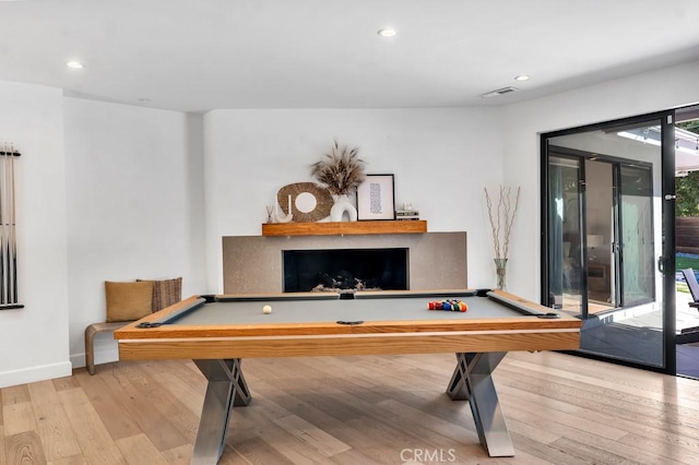 recreation room with billiards and light hardwood / wood-style flooring