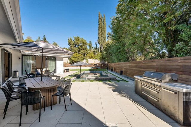 view of patio featuring area for grilling and exterior bar