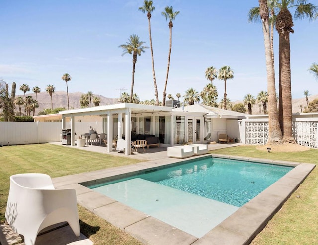 back of house with outdoor lounge area, a lawn, and a patio area