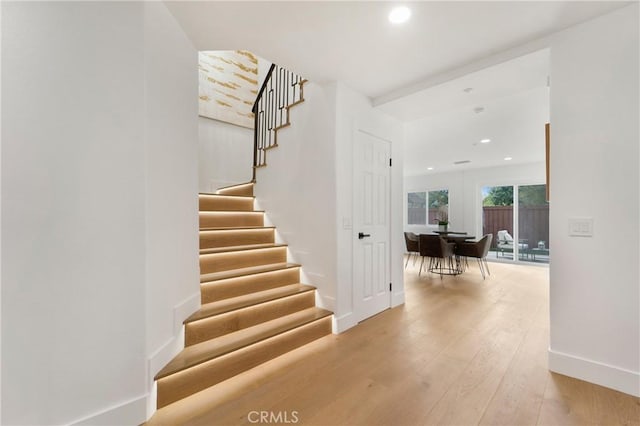 staircase with wood-type flooring