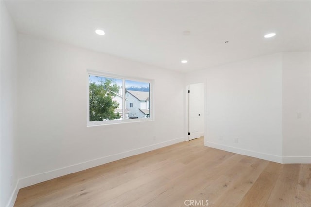 unfurnished room with light wood-type flooring